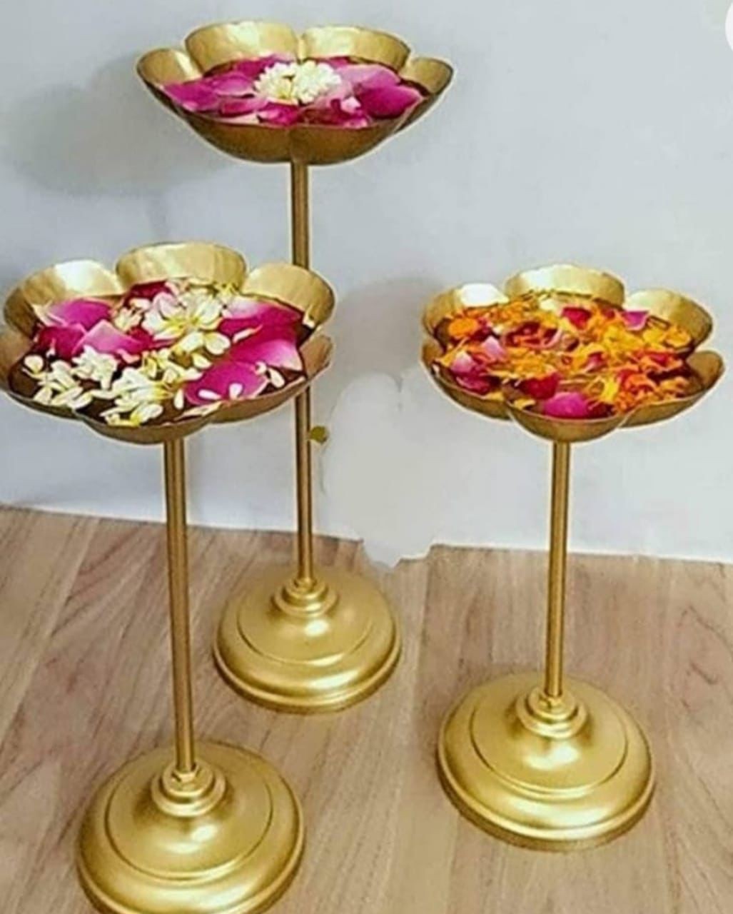 three golden urli stands,